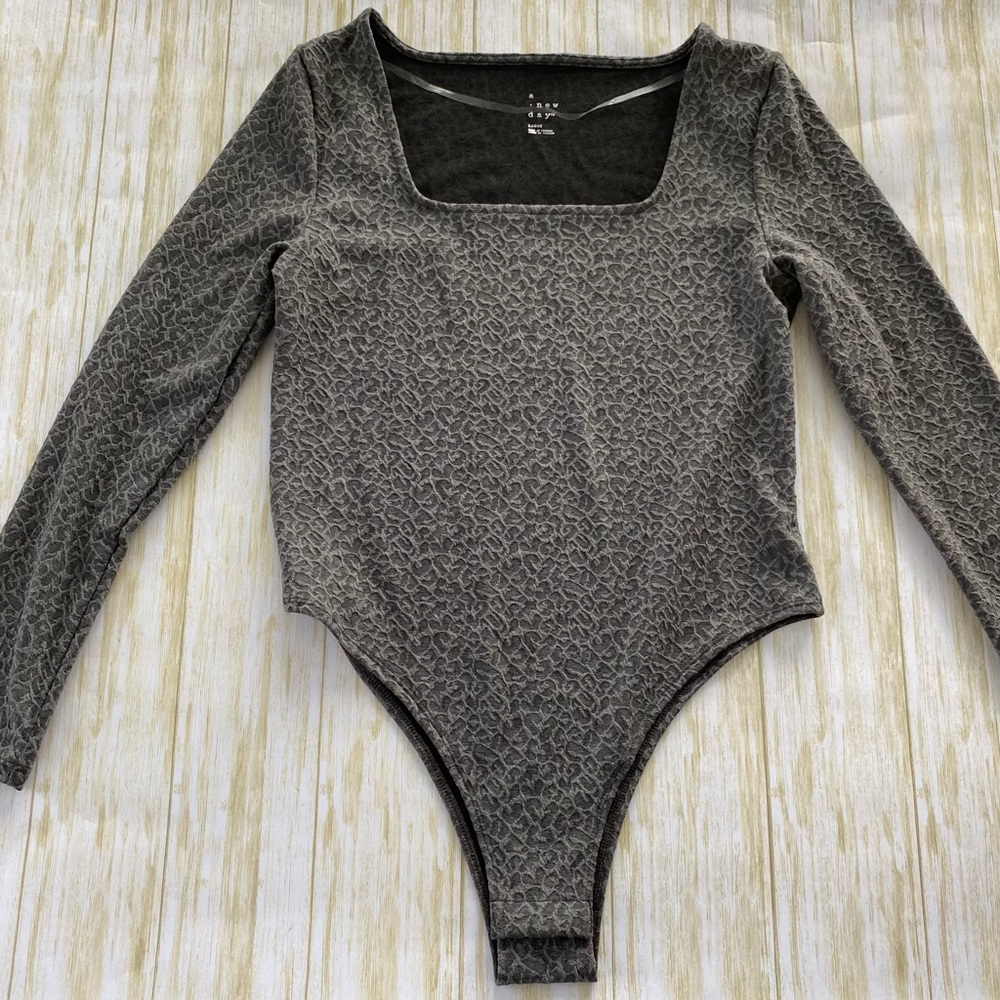 Woman’s long sleeve body suit size L